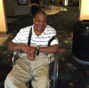 Man smiling in wheelchair.